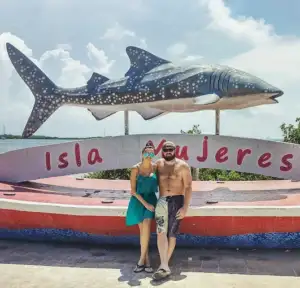 Boat rental in Marina Puerto Isla Mujeres with yacht cruising in clear Caribbean waters